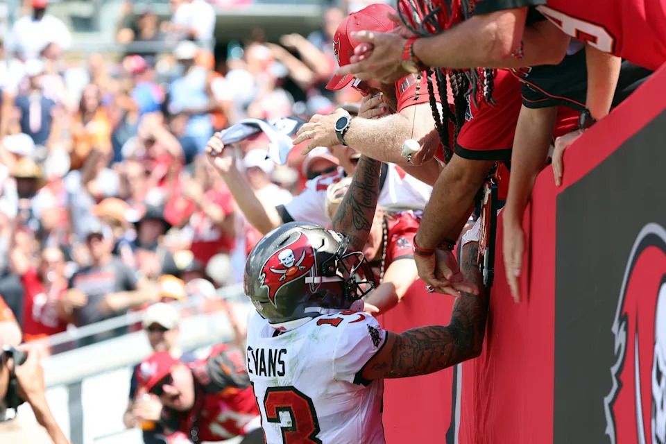 Sep 17, 2023; Tampa, Florida, USA; Tampa Bay Buccaneers wide receiver Mike Evans (13) celebrates with fans after scoring a touchdown against the Chicago Bears during the second half at Raymond James Stadium. Mandatory Credit: Kim Klement Neitzel-USA TODAY Sports