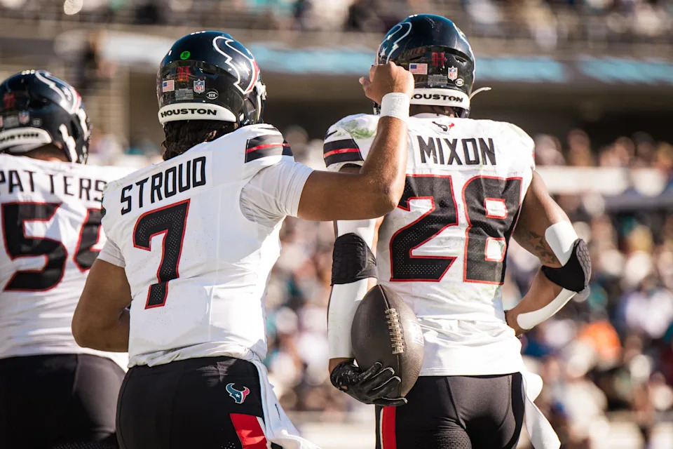 Dec 1, 2024; Jacksonville, Florida, USA; Houston Texans quarterback C.J. Stroud (7) and running back Joe Mixon (28) celebrate a touchdown in the third quarter at EverBank Stadium. Mandatory Credit: Jeremy Reper-Imagn Images