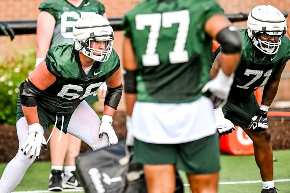 Michigan State's Gavin Broscious, left, and Kristian Phillips run an offensive line drill during the first day of football camp on Tuesday, July 30, 2024, in East Lansing.Nick King/Lansing State Journal / USA TODAY NETWORK