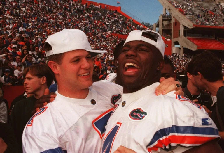 Florida's Danny Wuerffel, left, and Lawrence Wright share a laugh Jan. 11, 1997, at the Gators' national championship celebration at Ben Hill Griffin Stadium at Florida Field in Gainesville, Fla.