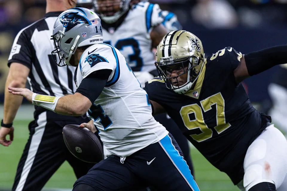 Jan 8, 2023; Carolina Panthers quarterback Sam Darnold (14) is pressured by New Orleans Saints defensive lineman Malcolm Roach (97). Mandatory Credit: Stephen Lew-Imagn Images