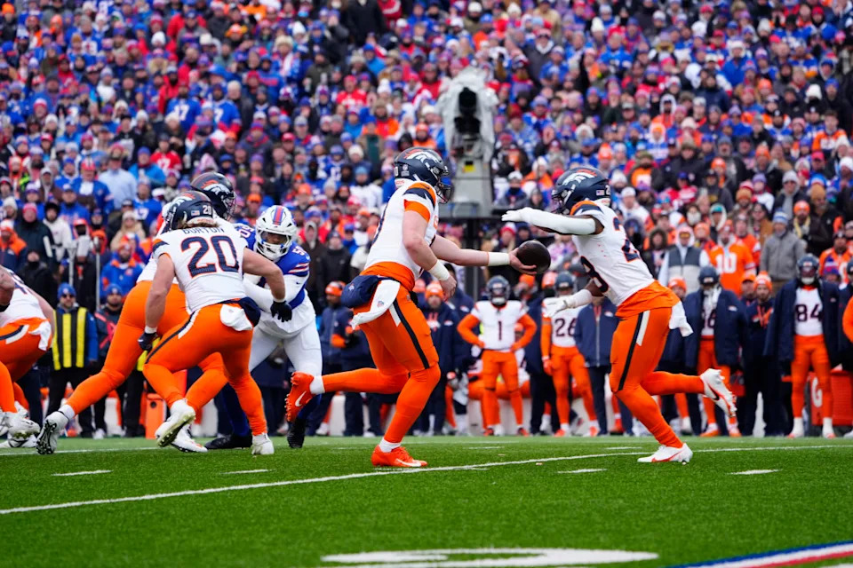 Denver Broncos quarterback Bo Nix (10) hands the ball off to Denver Broncos running back Tyler Badie (28) during the second quarter against the Buffalo Bills in an AFC wild card game at Highmark Stadium.Gregory Fisher-Imagn Images