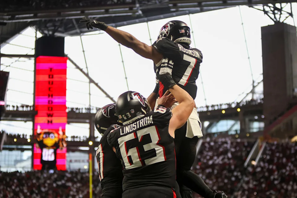 Jan 5, 2025; Atlanta, Georgia, USA; Atlanta Falcons running back Bijan Robinson (7) celebrates with teammates after a touchdown run against the Carolina Panthers in the second quarter at Mercedes-Benz StadiumBrett Davis Imagn Images