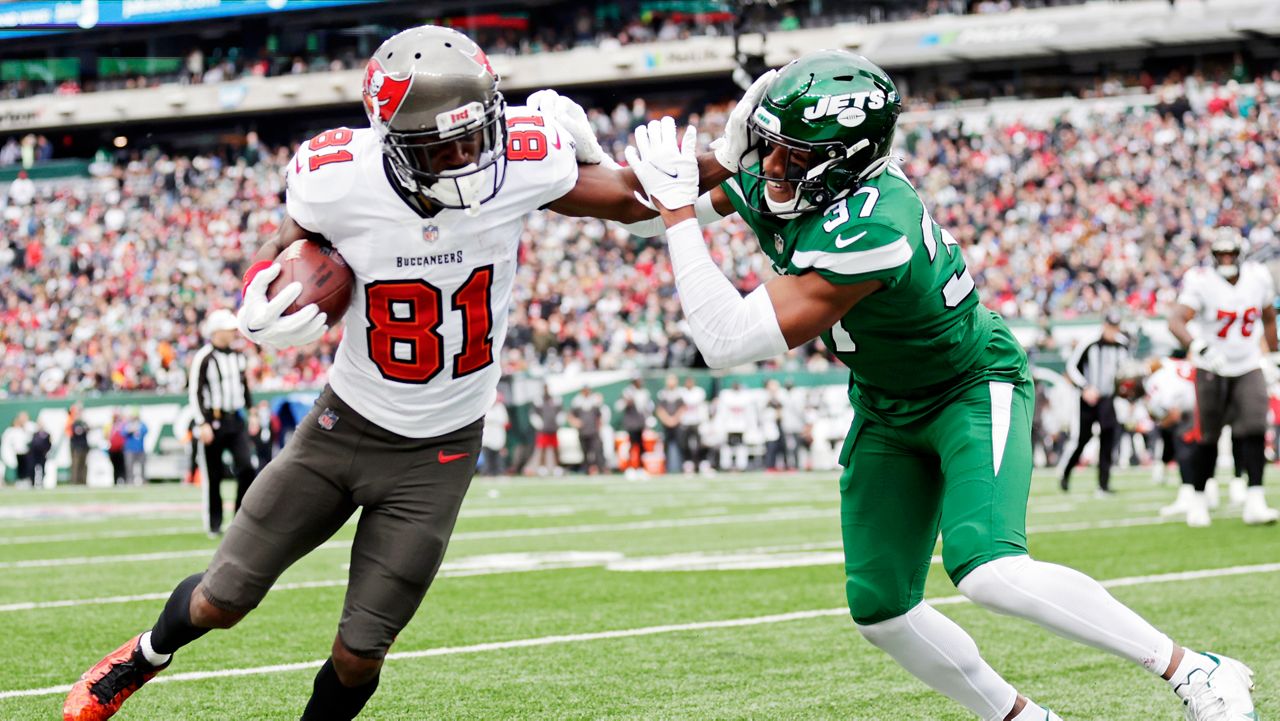 New York Jets cornerback Bryce Hall (37) tackles Tampa Bay Buccaneers wide receiver Antonio Brown (81) during an NFL football game, Sunday, Jan. 2, 2022, in East Rutherford, N.J. (AP Photo/Adam Hunger)