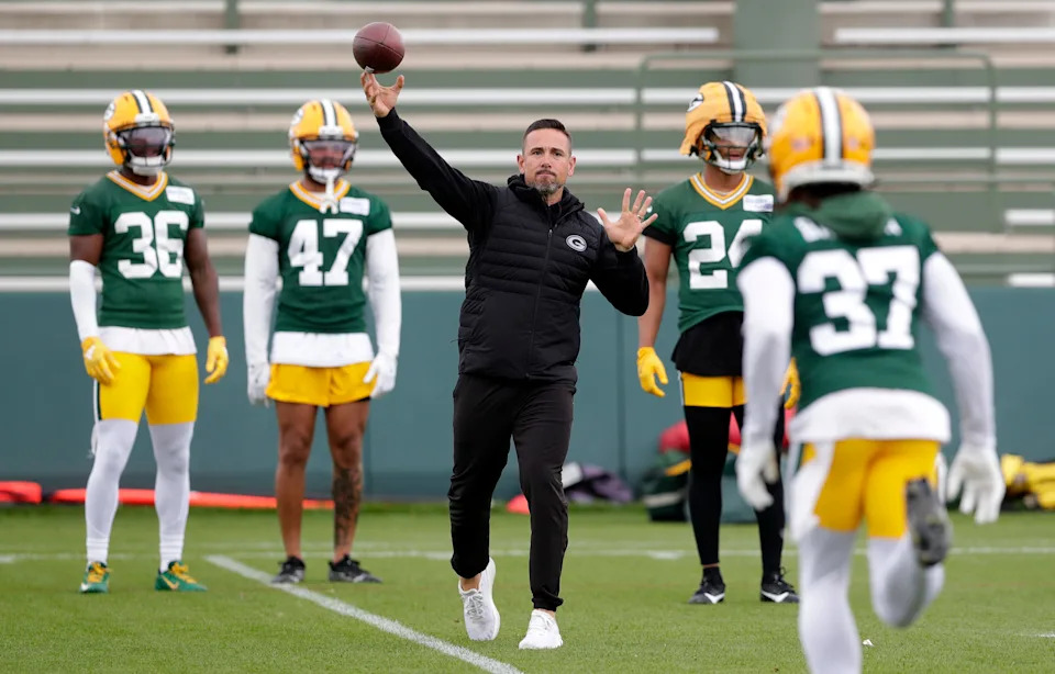 Packers coach Matt LaFleur throws the football to cornerback Johnathan Baldwin (37) during the first day of minicamp June 10 at Ray Nitschke Field.