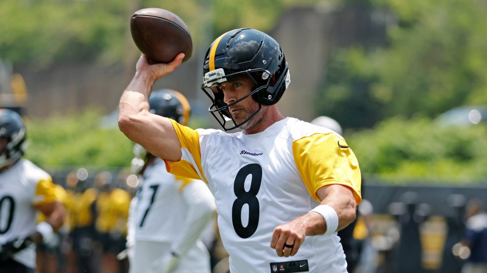 Aaron Rodgers, wearing a Pittsburgh Steelers uniform, throws a football.