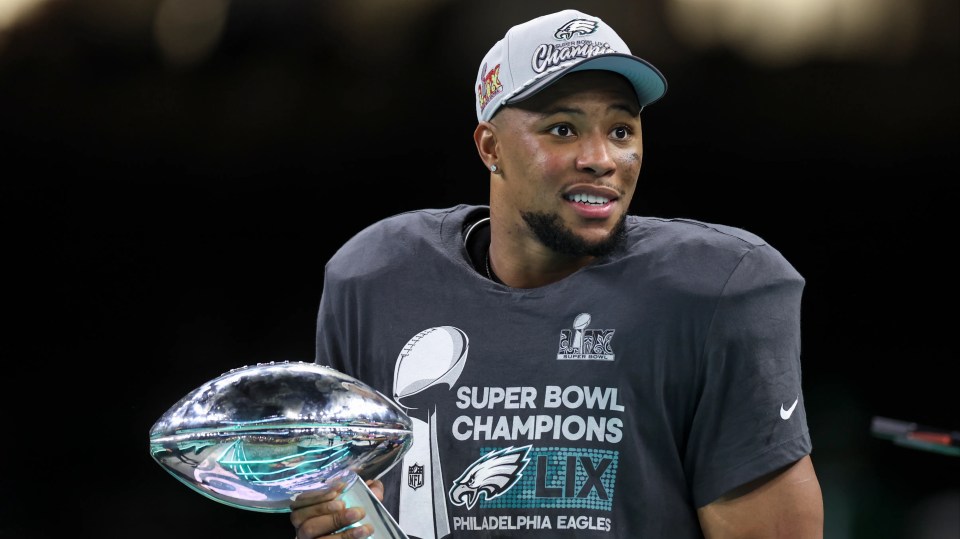 NEW ORLEANS, LOUISIANA - FEBRUARY 09: Saquon Barkley #26 of the Philadelphia Eagles holds the Vince Lombardi Trophy after winning Super Bowl LIX against the Kansas City Chiefs at Caesars Superdome on February 09, 2025 in New Orleans, Louisiana. The Eagles defeated the Chiefs 40-22. (Kara Durrette/Getty Images)