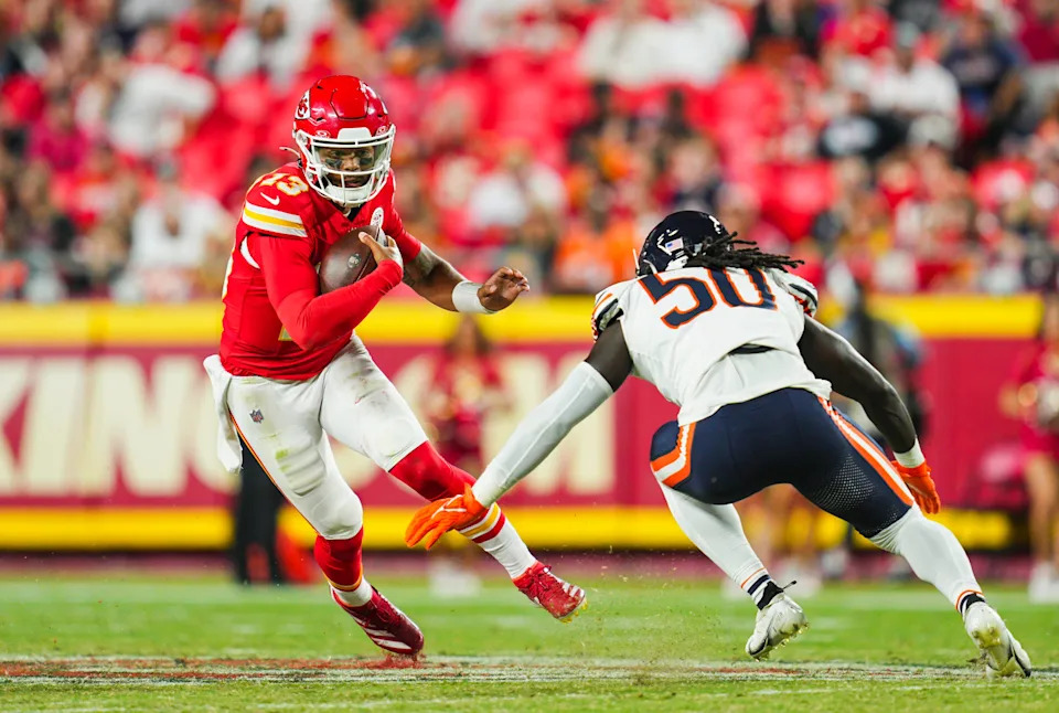 Aug 22, 2024; Kansas City, Missouri, USA; Kansas City Chiefs quarterback Chris Oladokun (13) runs the ball agianst Chicago Bears defensive end Carl Jones Jr. (50) during the first half at GEHA Field at Arrowhead Stadium. Mandatory Credit: Jay Biggerstaff-USA TODAY Sports