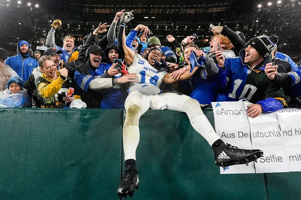 Detroit Lions wide receiver Amon-Ra St. Brown leaps into Lions fans as they celebrate the 24-14 win over the Green Bay Packers at Lambeau Field in Green Bay, Wis. on Sunday, Nov. 3, 2024.