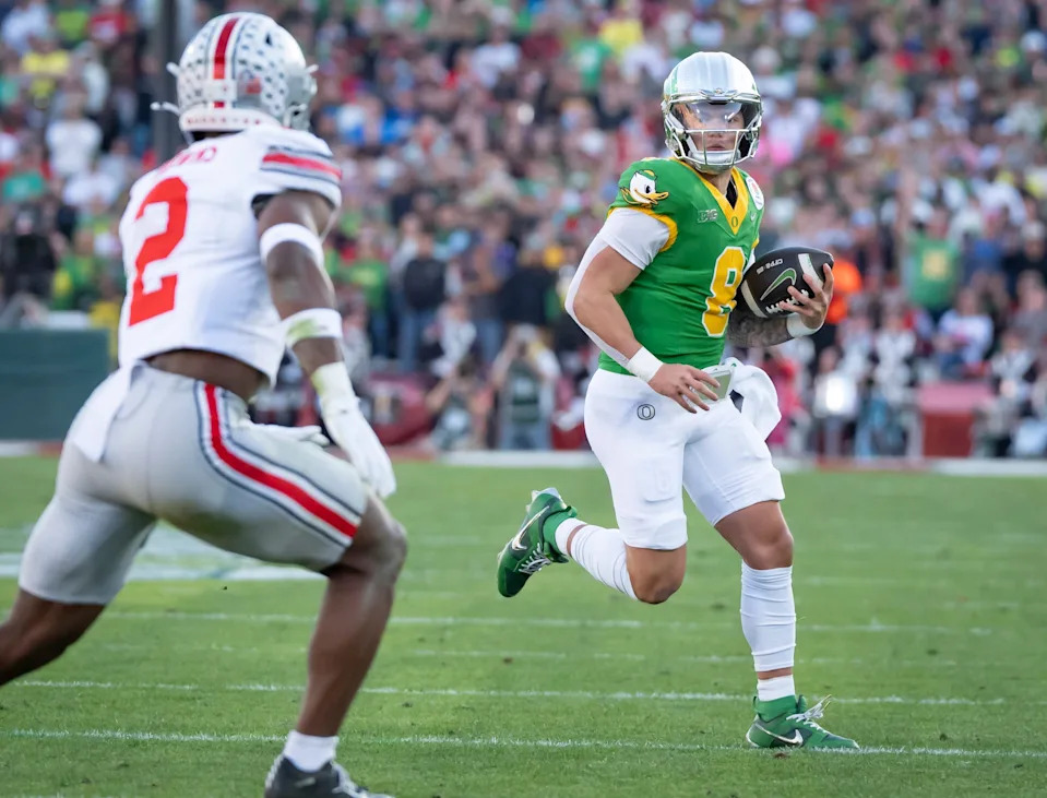 Oregon quarterback Dillon Gabriel scrambles with the ball as the Oregon Ducks face the Ohio State Buckeyes Wednesday, Jan. 1, 2025, in the quarterfinal of the College Football Playoff at the Rose Bowl in Pasadena, Calif.