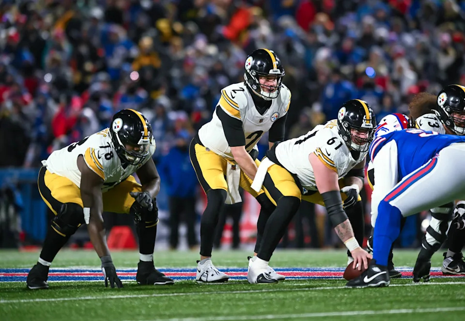 Pittsburgh Steelers quarterback Mason Rudolph (2) at the line of scrimmage with center Mason Cole (61) and guard James Daniels (78) against the Buffalo Bills in the third quarter of a 2024 AFC wild card game.Mark Konezny-Imagn Images