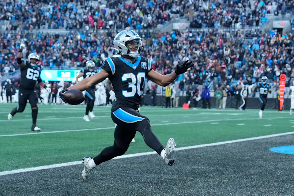 Dec 22, 2024; Charlotte, North Carolina, USA; Carolina Panthers running back Chuba Hubbard (30) scores in overtime to win the gqme at Bank of America Stadium. Mandatory Credit: Bob Donnan-Imagn Images
