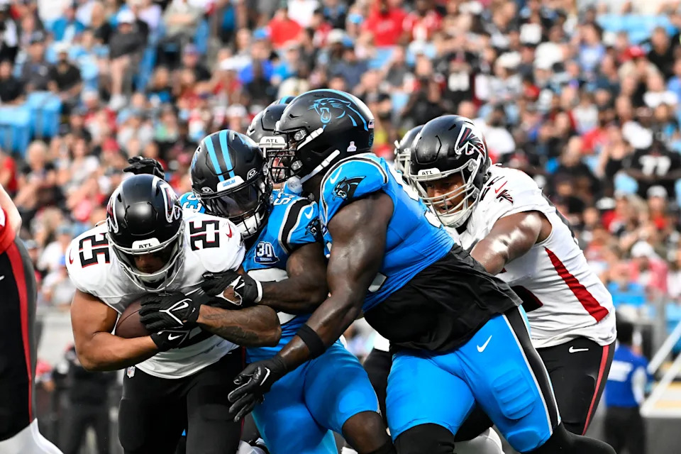 Oct 13, 2024; Charlotte, North Carolina, USA; Atlanta Falcons running back Tyler Allgeier (25) runs with the ball as Carolina Panthers linebacker Claudin Cherelus (53) defends in the third quarter at Bank of America Stadium. Mandatory Credit: Bob Donnan-Imagn Images