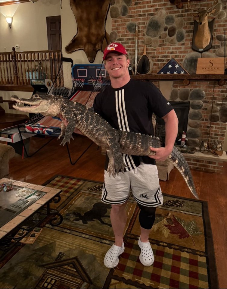 Man holding an alligator.