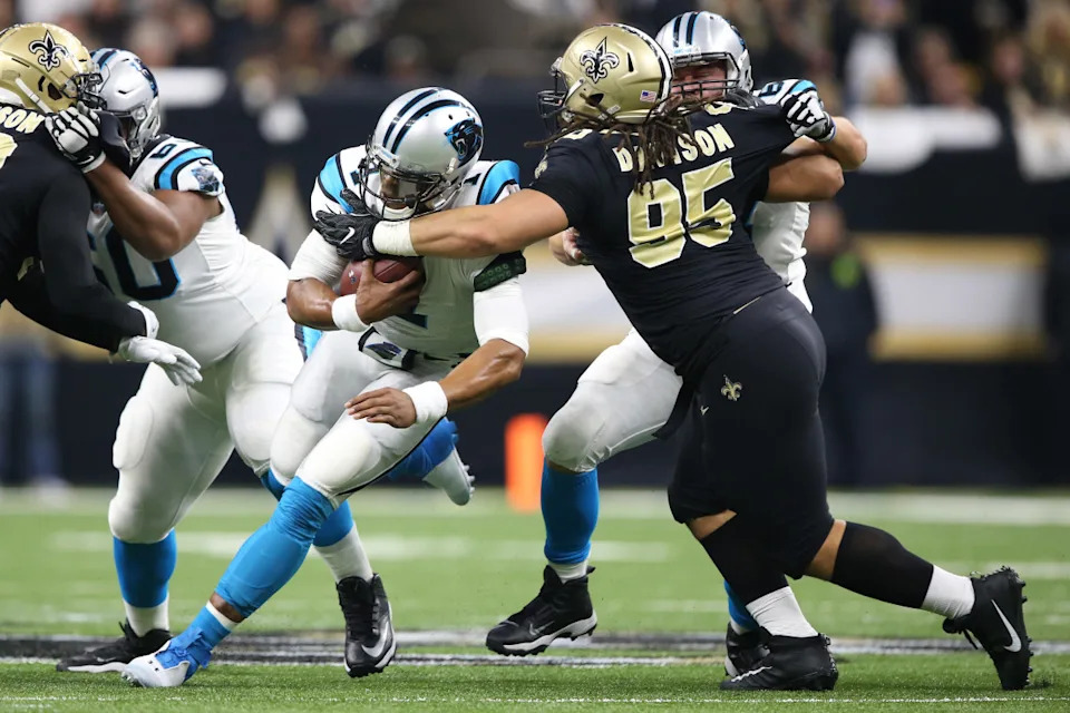 Jan 7, 2018; Carolina Panthers quarterback Cam Newton (1) is tackled by New Orleans Saints defensive tackle Tyeler Davison (95). Mandatory Credit: Chuck Cook-Imagn Images