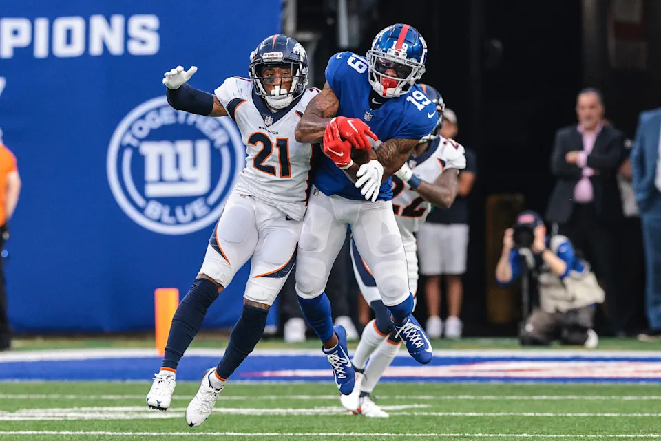 New York Giants wide receiver Kenny Golladay (19) catches the ball over Denver Broncos cornerback Ronald Darby (21) during the second half at MetLife Stadium.Vincent Carchietta-Imagn Images