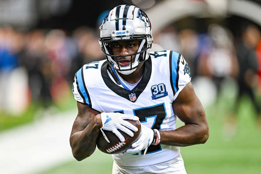 Xavier Legette holding a ball on the field during the warm-up prior to a game.