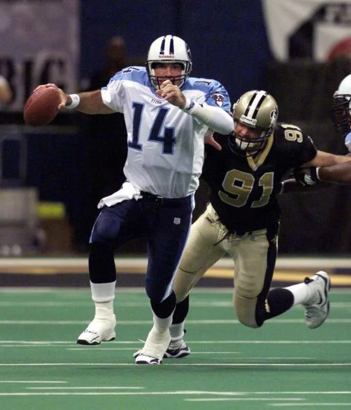 Oct. 17, 1999; Tennessee Titans quarterback Neil O'Donnell (14) under pressure from New Orleans Saints defender Brady Smith. © George Walker IV / The Tennessean / USA TODAY NETWORK via Imagn Images