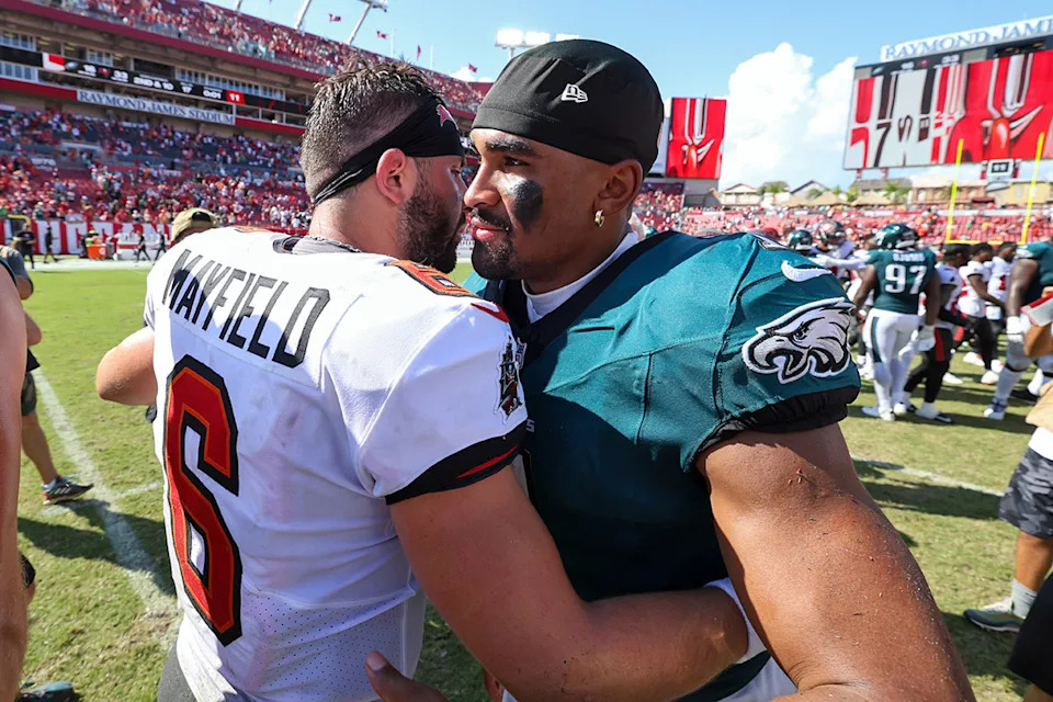 Sep 29, 2024; Tampa, Florida, USA; Philadelphia Eagles quarterback Jalen Hurts (1) greets Tampa Bay Buccaneers quarterback Baker Mayfield (6) after a game at Raymond James Stadium.Nathan Ray Seebeck-Imagn Images
