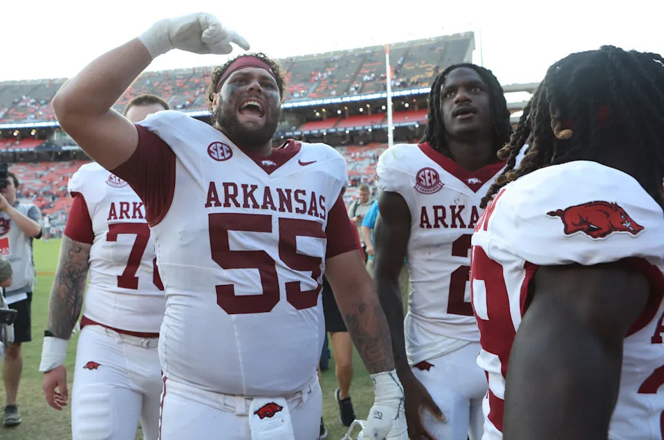 Sep 21, 2024; Auburn, Alabama, USA; Arkansas Razorbacks offensive lineman Fernando Carmona (55) celebrates with fans after the Razorbacks beat the Auburn Tigers at Jordan-Hare Stadium. Mandatory Credit: John Reed-Imagn Images
