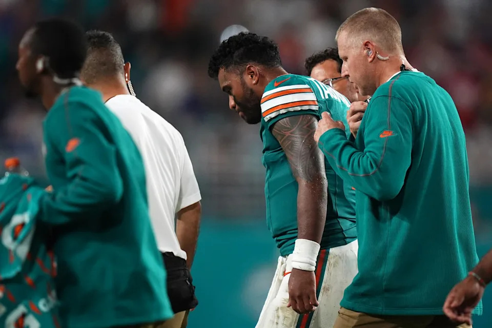 Miami Dolphins quarterback Tua Tagovailoa (1) walks off the field with training staff after an apparent injury during the second half against the Buffalo Bills at Hard Rock Stadium.Jasen Vinlove-Imagn Images