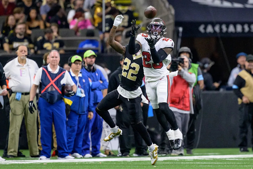 Oct 13, 2024; New Orleans, Louisiana, USA; Tampa Bay Buccaneers safety Tykee Smith (23) grabs a interception of a ball intended for New Orleans Saints wide receiver Rashid Shaheed (22) during the fourth quarter at Caesars Superdome. Mandatory Credit: Matthew Hinton-Imagn Images