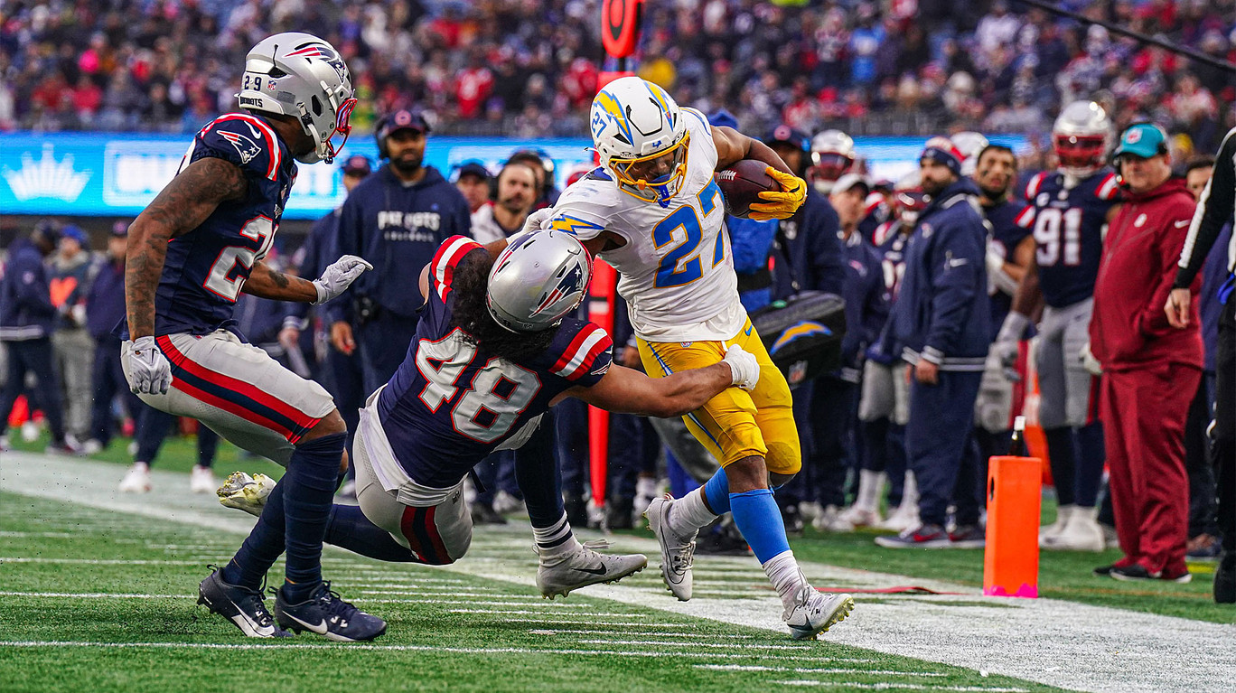 Los Angeles Chargers running back J.K. Dobbins (27) runs the ball against New England Patriots linebacker Jahlani Tavai (48) in the second half at Gillette Stadium.