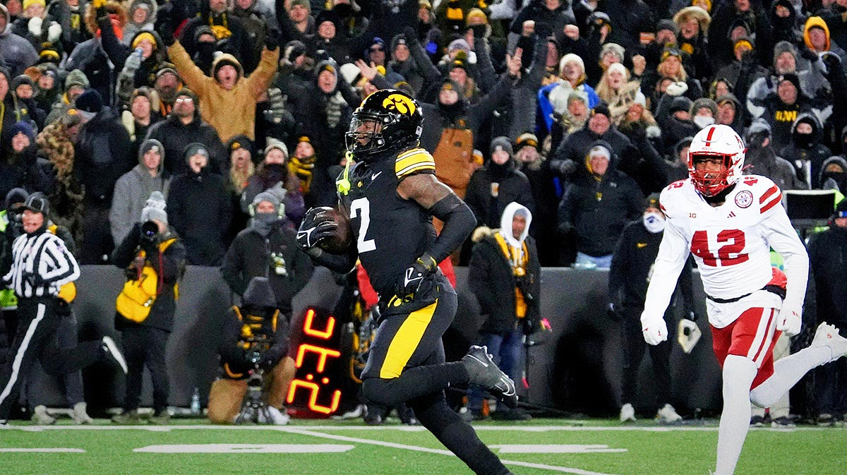 Iowa Hawkeyes running back Kaleb Johnson (2) runs to the endzone to score a touchdown as DUPLICATE***Nebraska Cornhuskers linebacker Mikai Gbayor (42) trails Friday, Nov. 29, 2024 at Kinnick Stadium in Iowa City, Iowa.