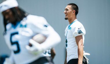 Tetairoa McMillan making progress, with tutors on both sides of the ball