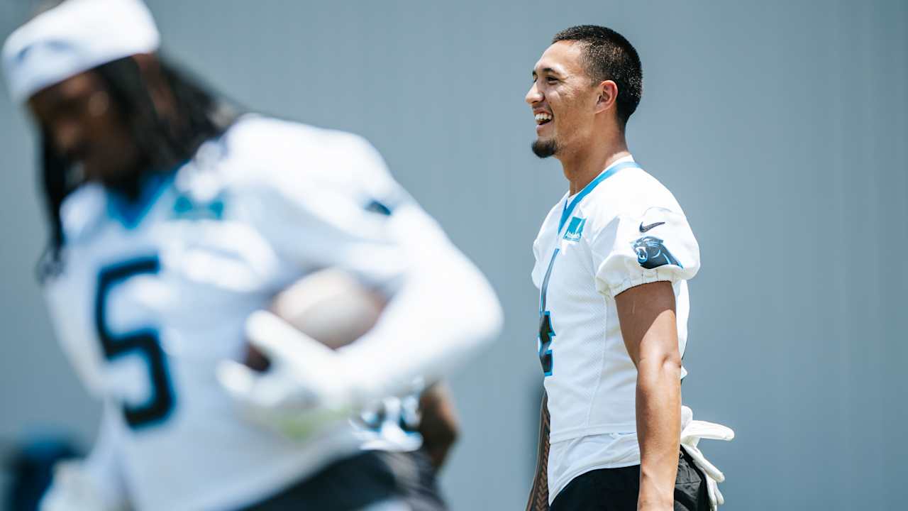 Tetairoa McMillan making progress, with tutors on both sides of the ball