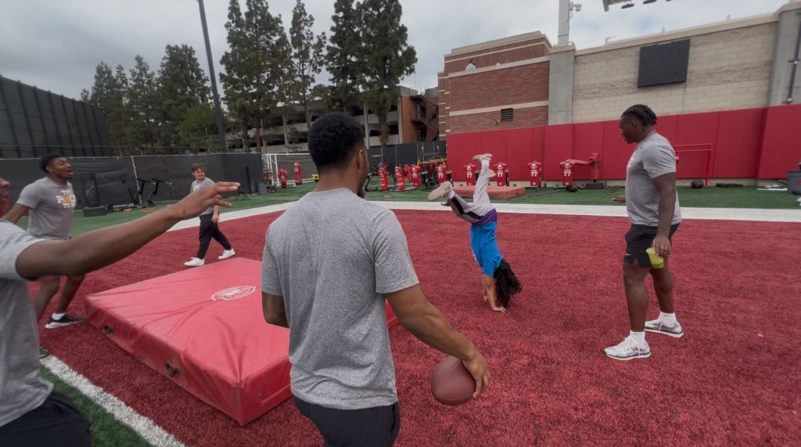 Players celebrate an athletic handstand celebration
