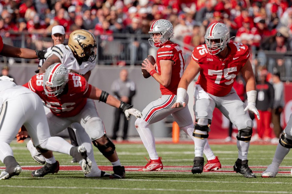 Ohio State quarterback Will Howard looks for a receiver during a football game.