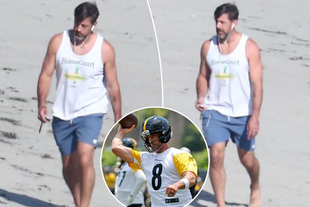 Aaron Rodgers takes beach walk as mystery wife remains out of sight