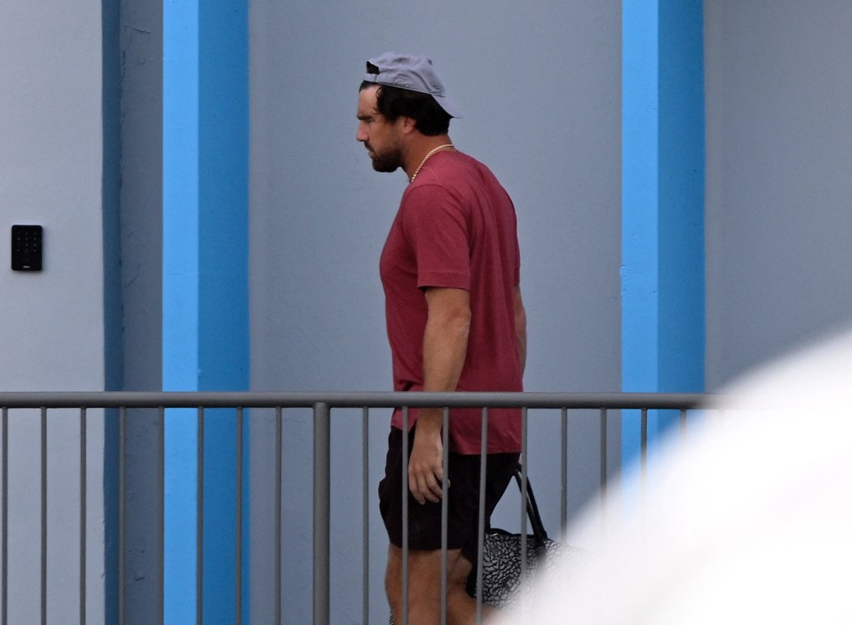 Travis Kelce walking, carrying a bag.