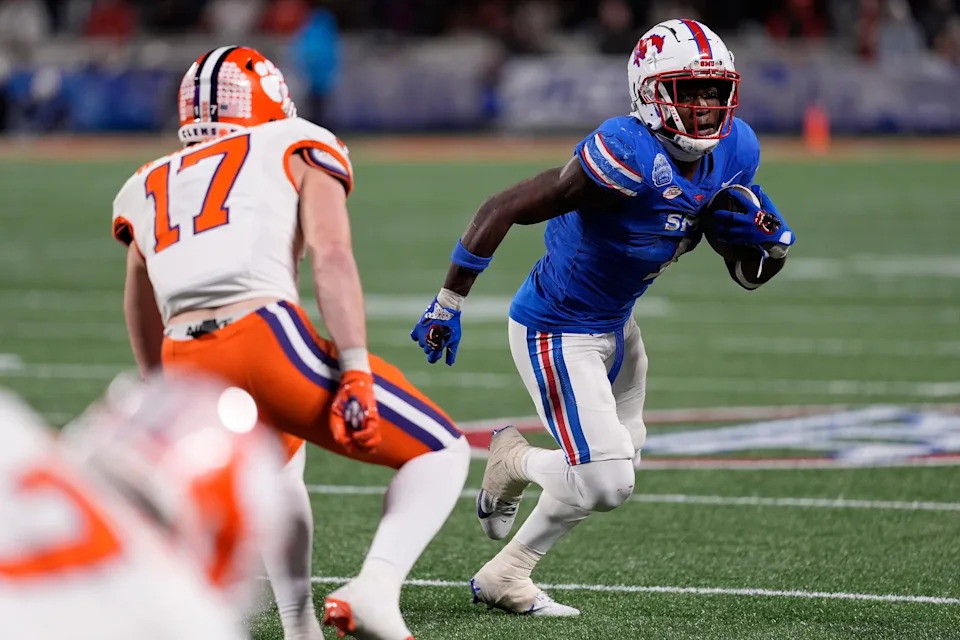 Dec 7, 2024; Charlotte, NC, USA; Southern Methodist Mustangs running back Brashard Smith (1) runs against Clemson Tigers linebacker Wade Woodaz (17) during the fourth quarter in the 2024 ACC Championship game at Bank of America Stadium. Mandatory Credit: Jim Dedmon-Imagn Images