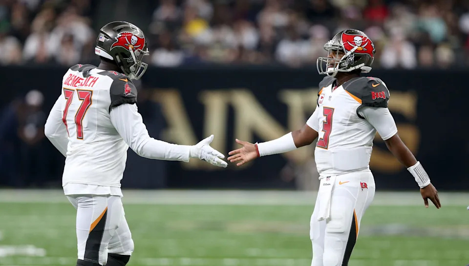 Dec 24, 2016; New Orleans, LA, USA; Tampa Bay Buccaneers offensive guard Caleb Benenoch (77) greets quarterback Jameis Winston (3) in the second quarter against the New Orleans Saints at the Mercedes-Benz Superdome. Mandatory Credit: Chuck Cook-USA TODAY Sports