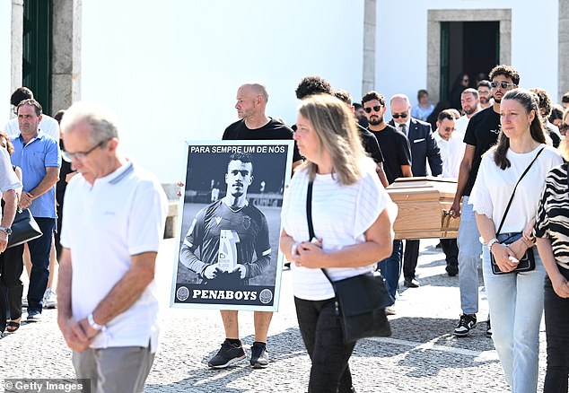 A poster of Andre Silva is carried as the coffins are walked to the Church ahead of the funeral for him and his brother Diogo Jota
