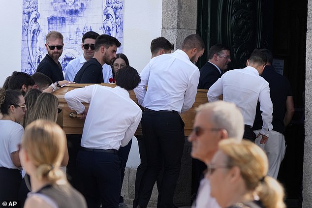 Jota's wife Rute Cardoso places her hand on the coffin of her late husband as it is taken inside the Igreja Matriz de Gondomar