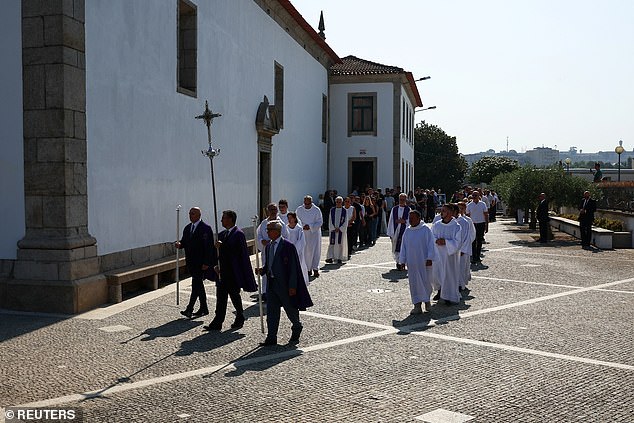 Members of the church lead the procession as its makes it way through the streets of Gondomar