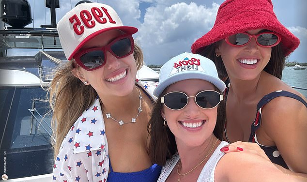Brittany poses for a photo with pals as they toast the holiday onboard a yacht