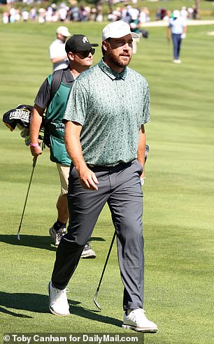 Travis smiles at the crowds following him and his brother around the course
