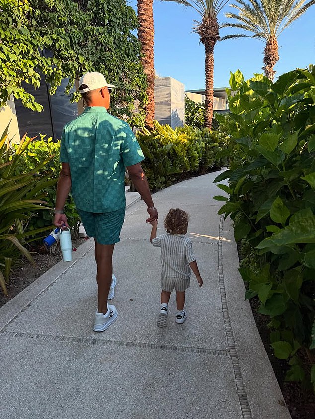 Chiefs quarterback Mahomes holding hands with son 'Bronze' as they walked down a path on the holiday resort
