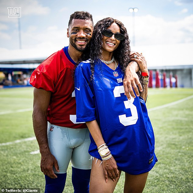 Wilson, pictured with Ciara on his first day at Giants practice, signed with the team in March