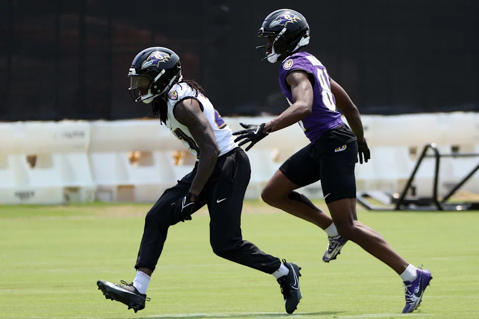 Jun 11, 2025; Baltimore, MD, USA; Baltimore Ravens cornerback T.J. Tampa (27) and Baltimore Ravens wide receiver Devontez Walker (81) run to the football during an NFL OTA at Under Armour Performance Center. Mandatory Credit: Daniel Kucin Jr.-Imagn Images