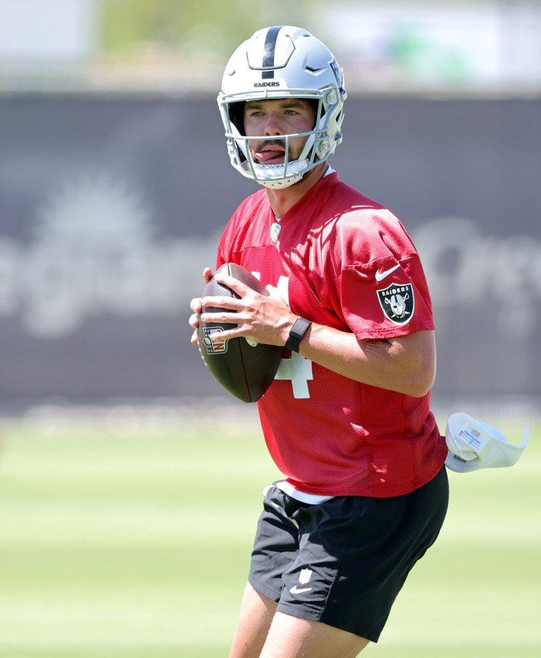 Las Vegas Raiders quarterback Carter Bradley #14 throws a football.