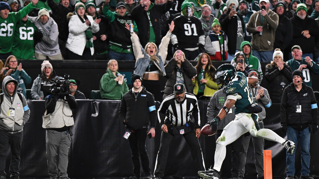 Saquon Barkley runs the ball and crosses the goal line for a touchdown during the second half of an NFL football game against the Washington Commanders, Thursday, Nov. 14, 2024.