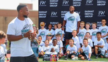 Philadelphia Eagles' Dentist hands the ball off to Saquon Barkley in football camp