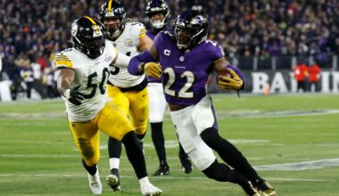 Jan 11, 2025; Baltimore, Maryland, USA; Baltimore Ravens running back Derrick Henry (22) runs against Pittsburgh Steelers linebacker Elandon Roberts (50) in the second quarter in an AFC wild card game at M&T Bank Stadium.