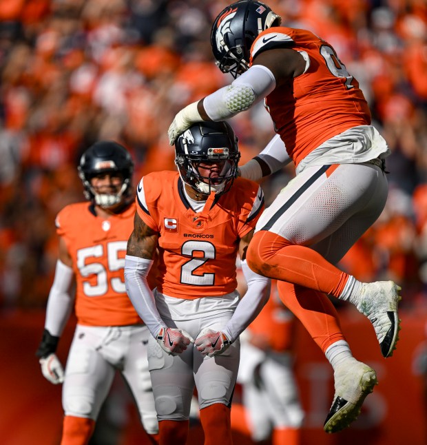 Pat Surtain II (2) of the Denver Broncos celebrates making a tackle for a loss on fourth down against the Carolina Panthers as Malcolm Roach (97) rejoices during the second quarter at Empower Field at Mile High in Denver on Sunday, Oct. 27, 2024. (Photo by AAron Ontiveroz/The Denver Post)