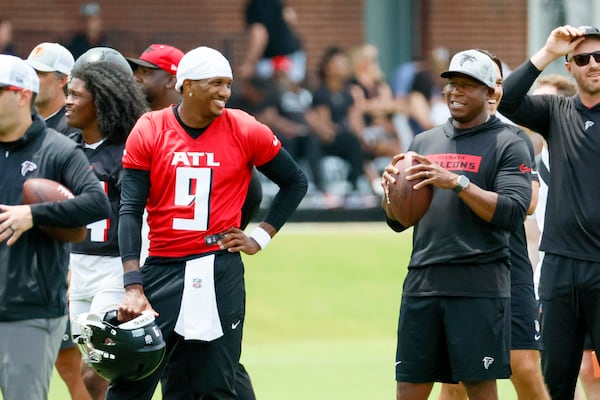 Falcons quarterback Michael Penix Jr. (left) smiles with head coach Raheem Morris during minicamp. Penix’s development isn’t the only thing on Morris’ to-do list when players report to Flowery Branch on Wednesday for training camp. (Miguel Martinez/AJC)